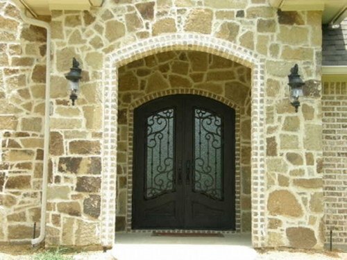 French Country Entry with Iron Doors and Brick and Stone 